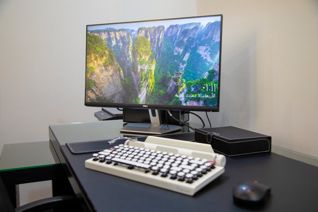 Black flat screen computer monitor on white computer keyboard