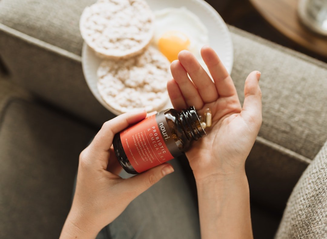 Person holding red bottle