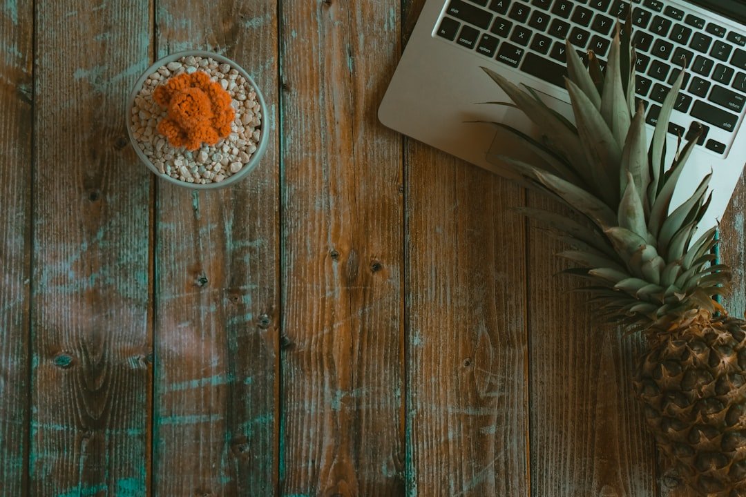 Eating every few hours: Brown pineapple beside macbook