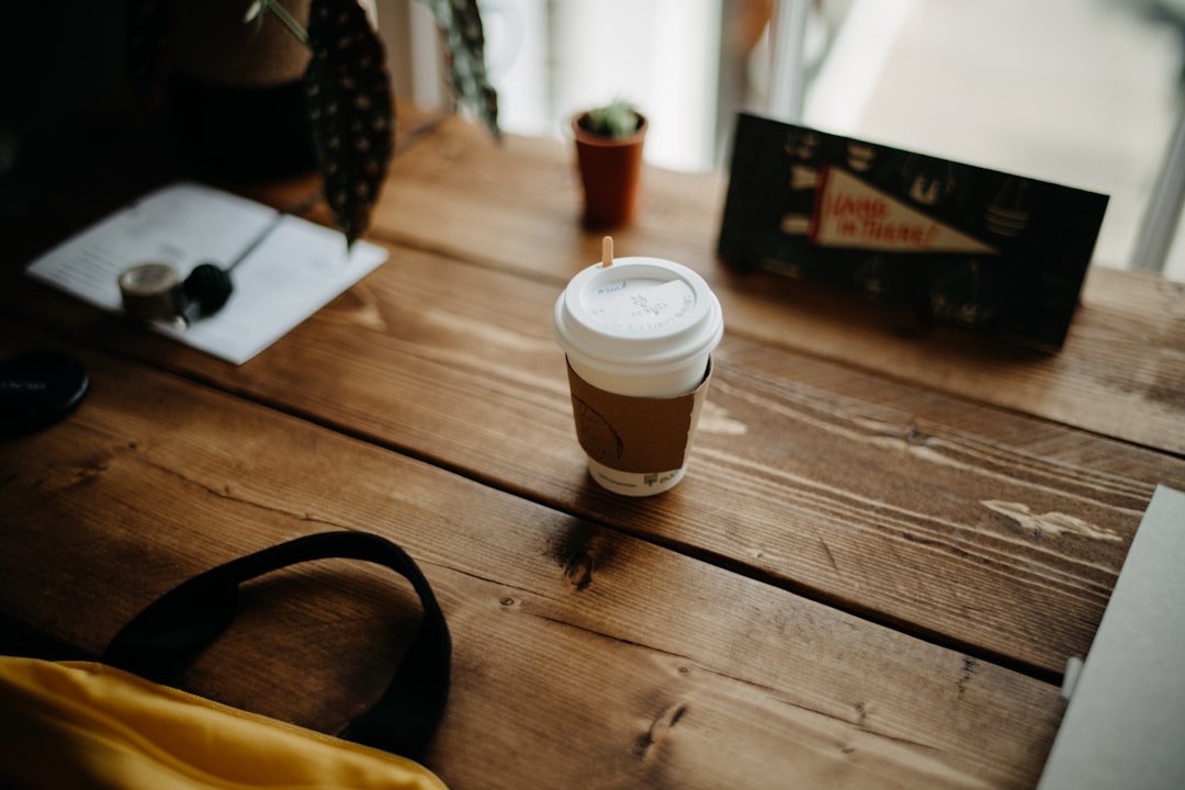 A cup of coffee sitting on top of a wooden table