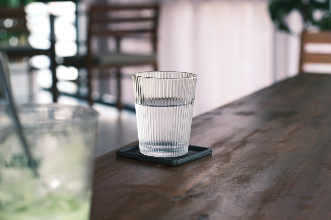 A clear glass of water on a wooden table
