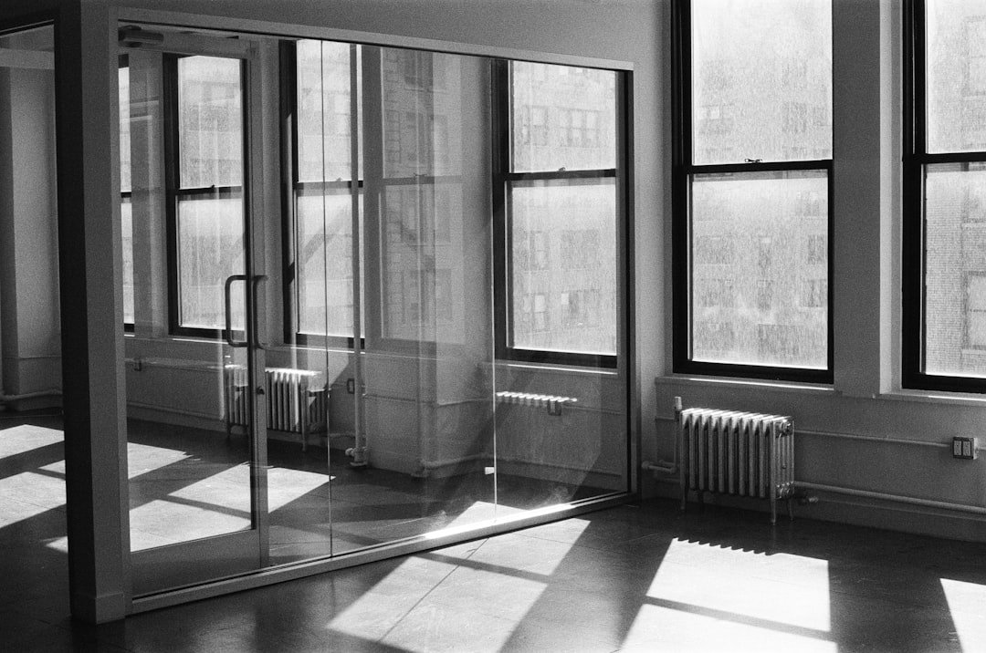 Sunlight fills an empty room with large windows