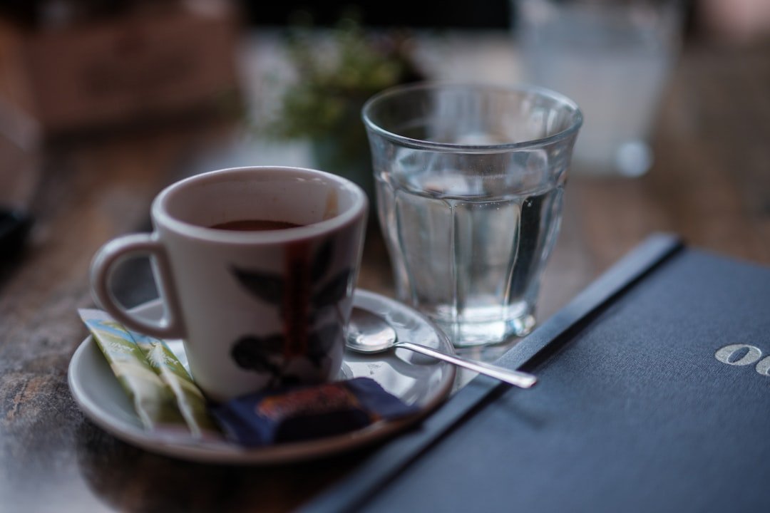 A glass of water and a book on a table