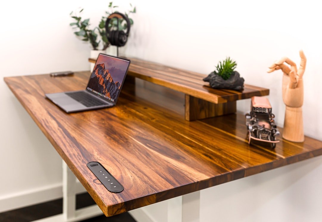 Standing desks: A wooden desk with a laptop on it