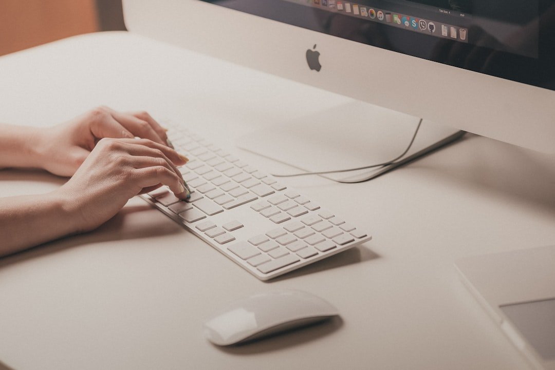 Person typing on apple keyboard