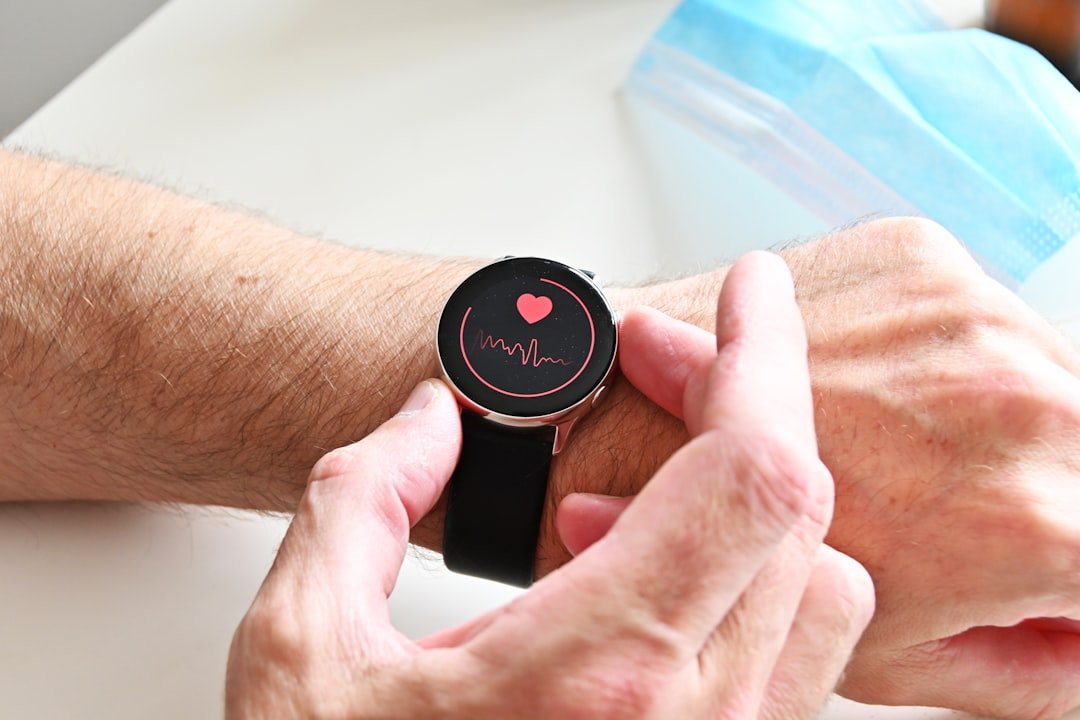 A person checking a heart rate monitor on a smartwatch on their wrist