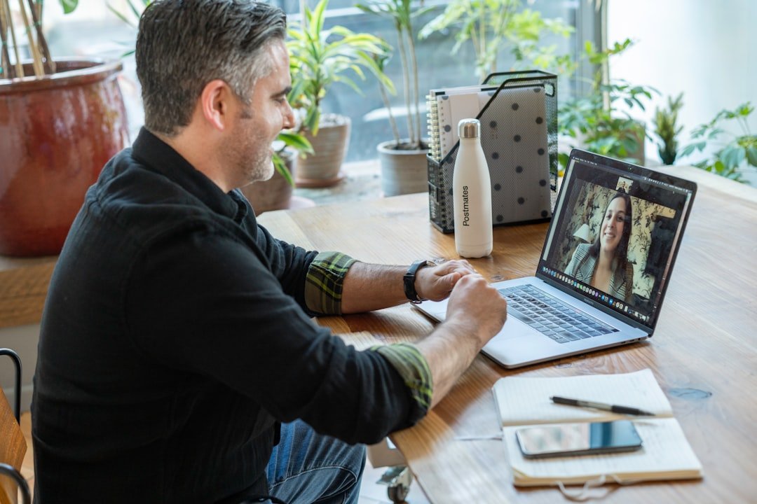 Man in black sweater using macbook pro