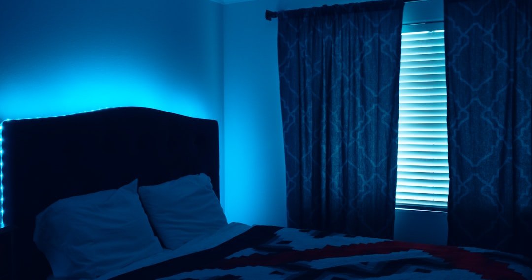 White pillow on bed near window