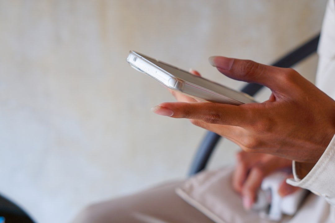 A close up of a person holding a cell phone