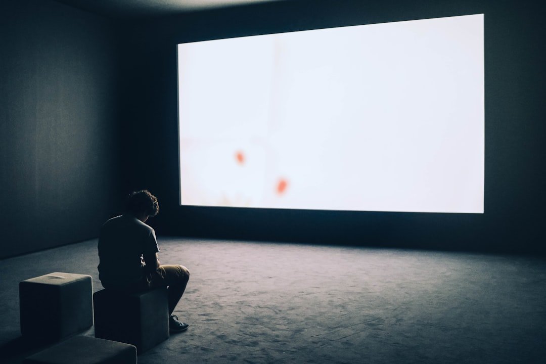 Man sit in front projector screen