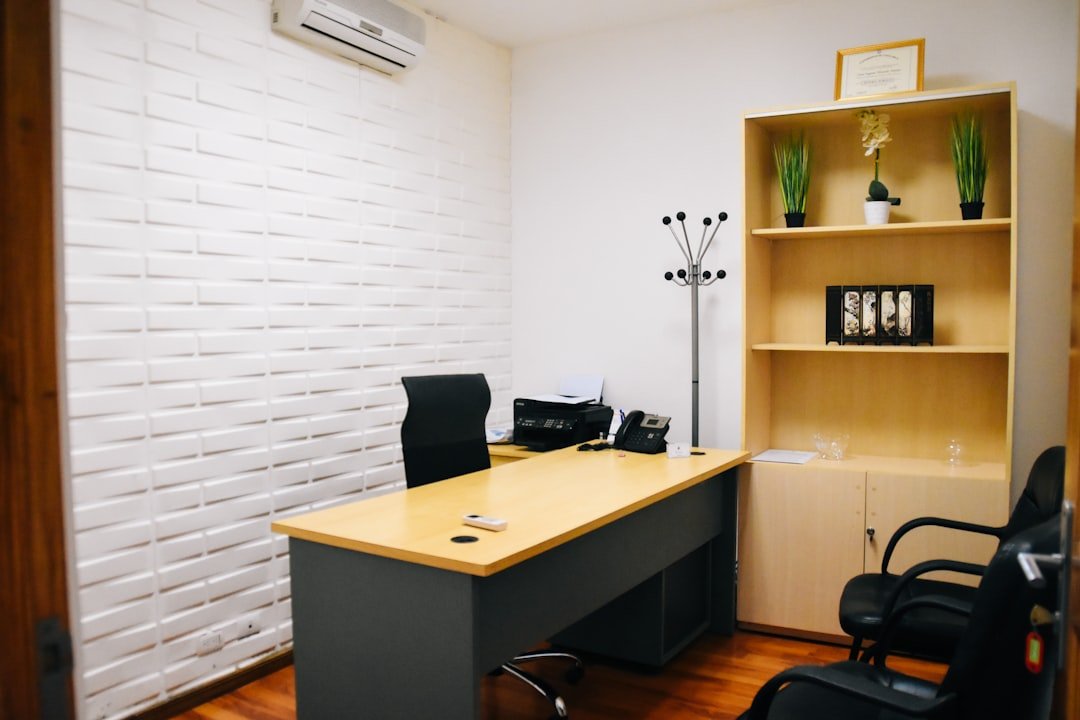 Black office rolling chair beside brown wooden table