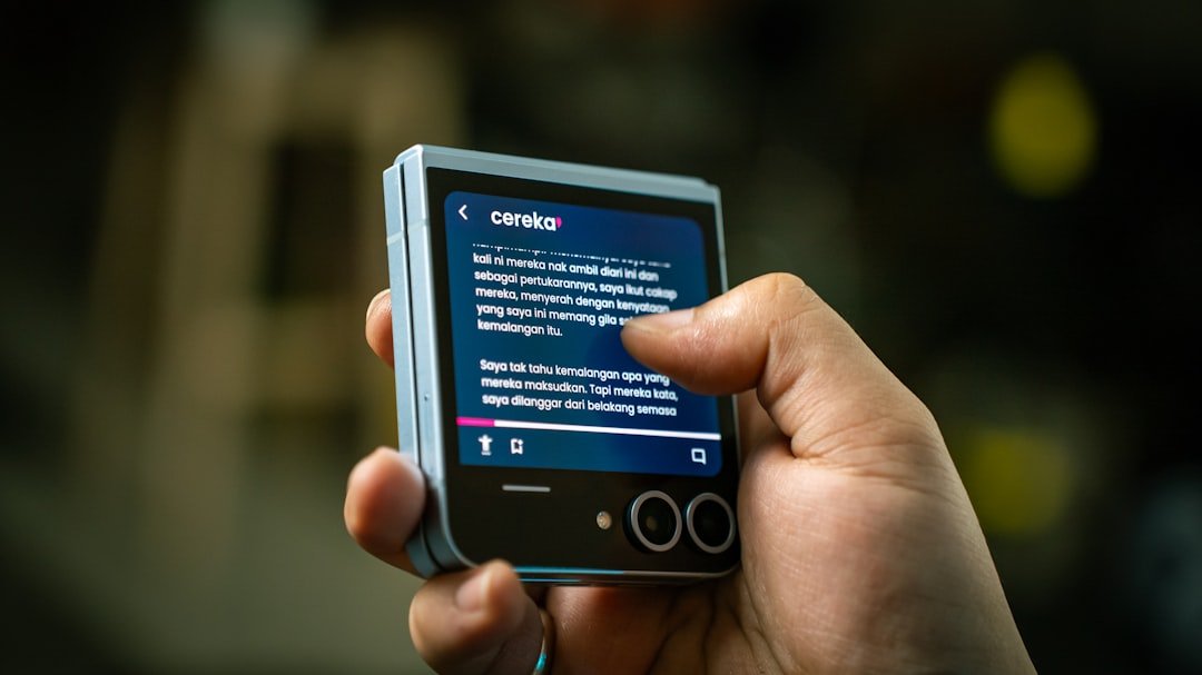 A person holding a smart phone in their hand