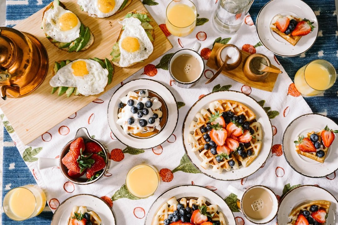 Breakfast spread with waffles eggs and juice