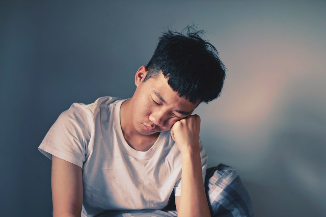 Man resting his cheeks on hand