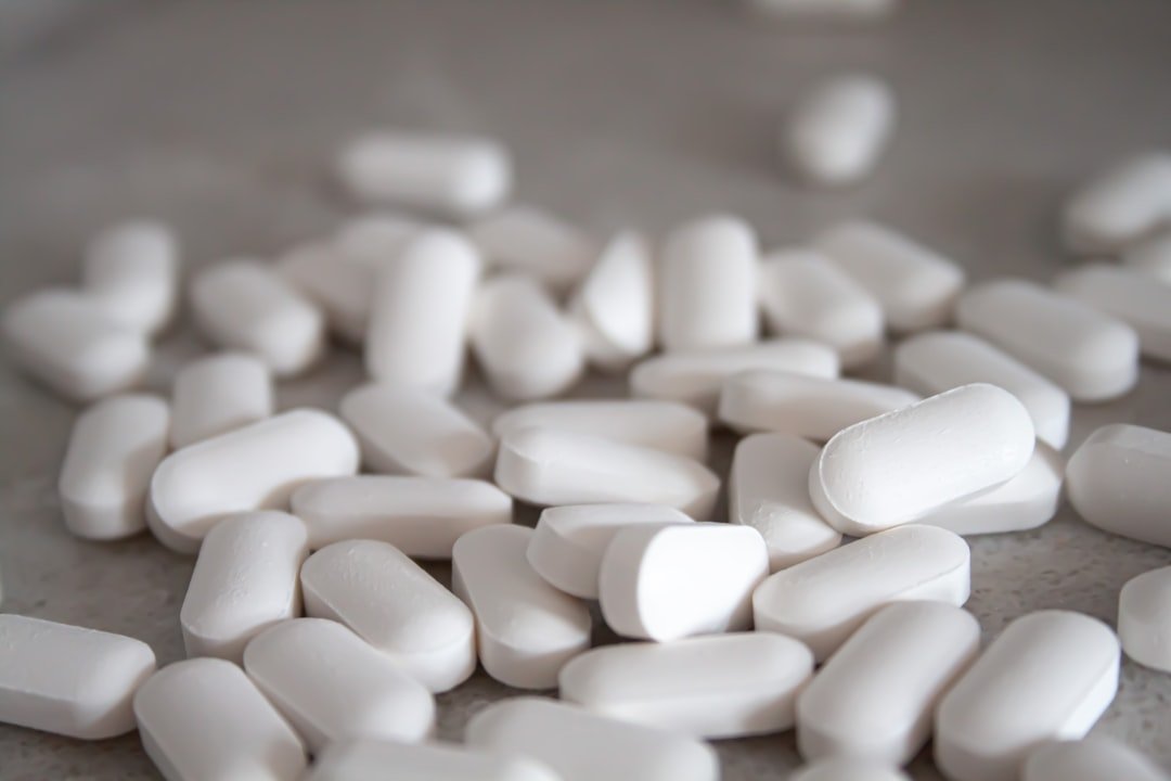 White medication pills on brown surface