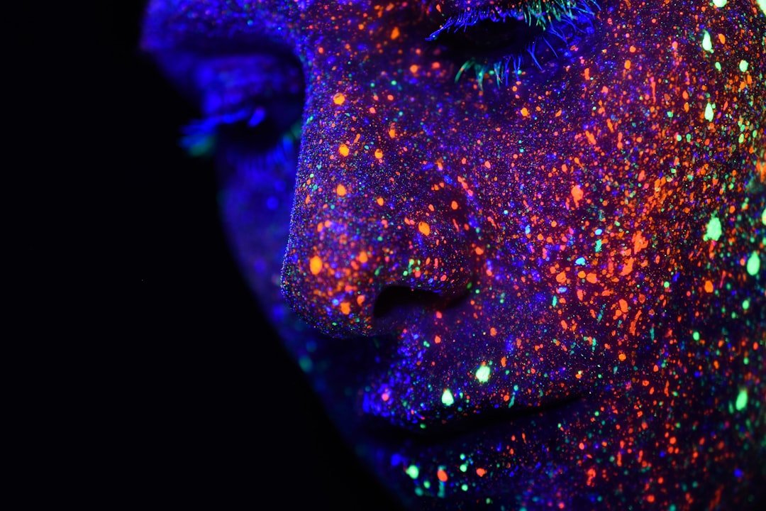 Person with assorted-color paint on face