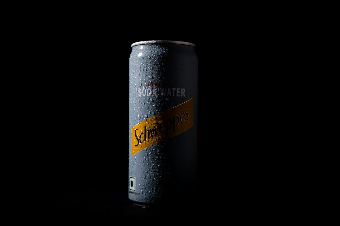 A can of soda on a black background