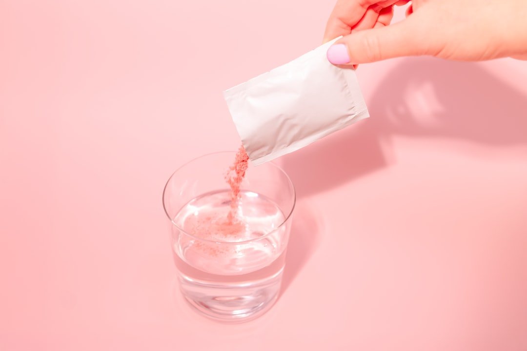 A person pouring a drink into a glass