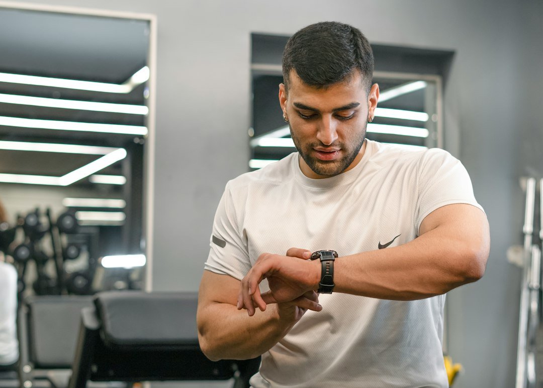 Man checking smartwatch in a gym