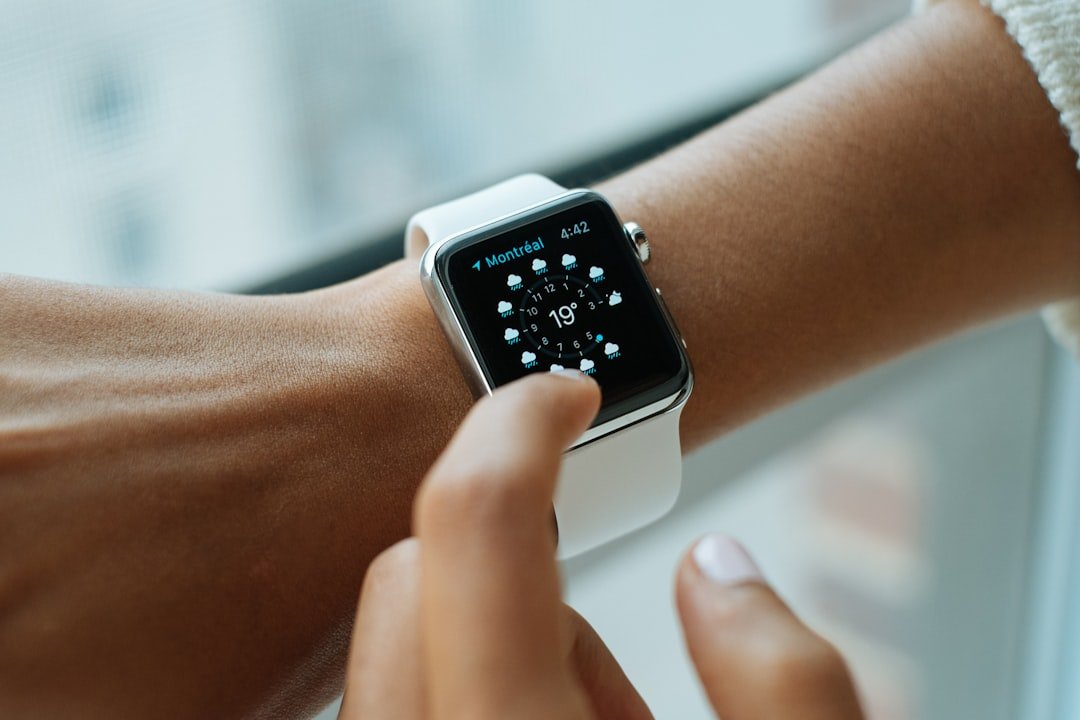 Person wearing silver aluminium case apple watch with white sports band