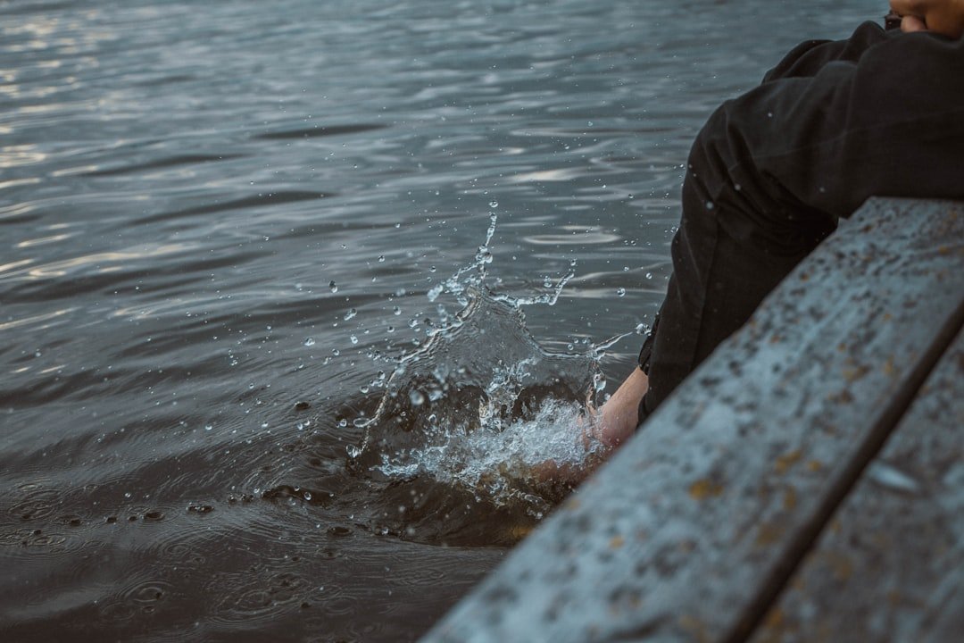 A person sitting on a bench in the water