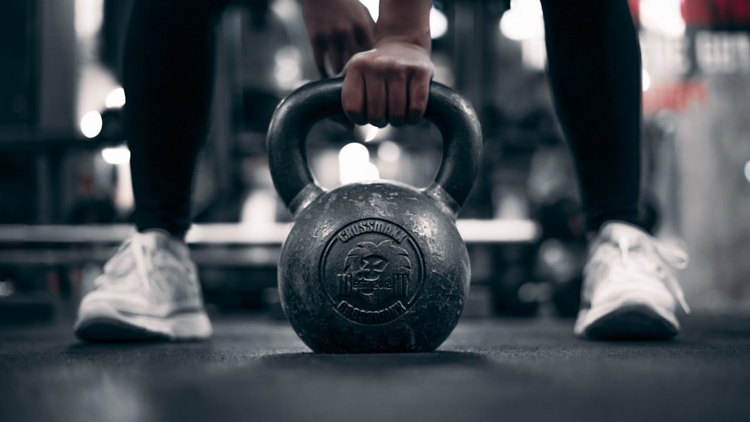 A person holding a kettle in a gym
