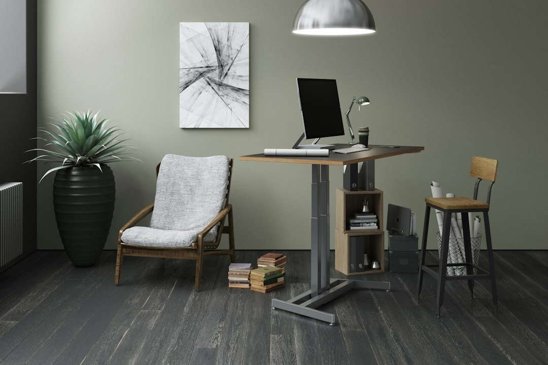 Silver laptop computer on brown wooden table