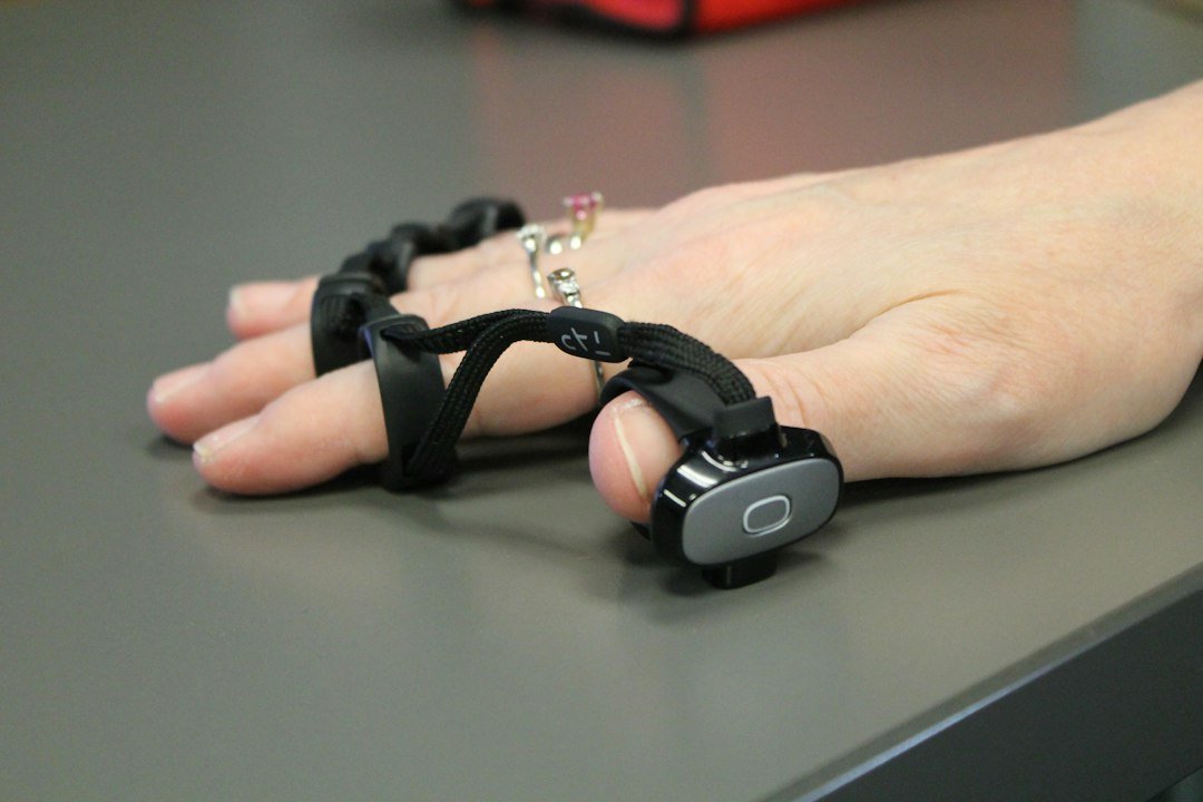 A person's hand on a table with a chain attached to it